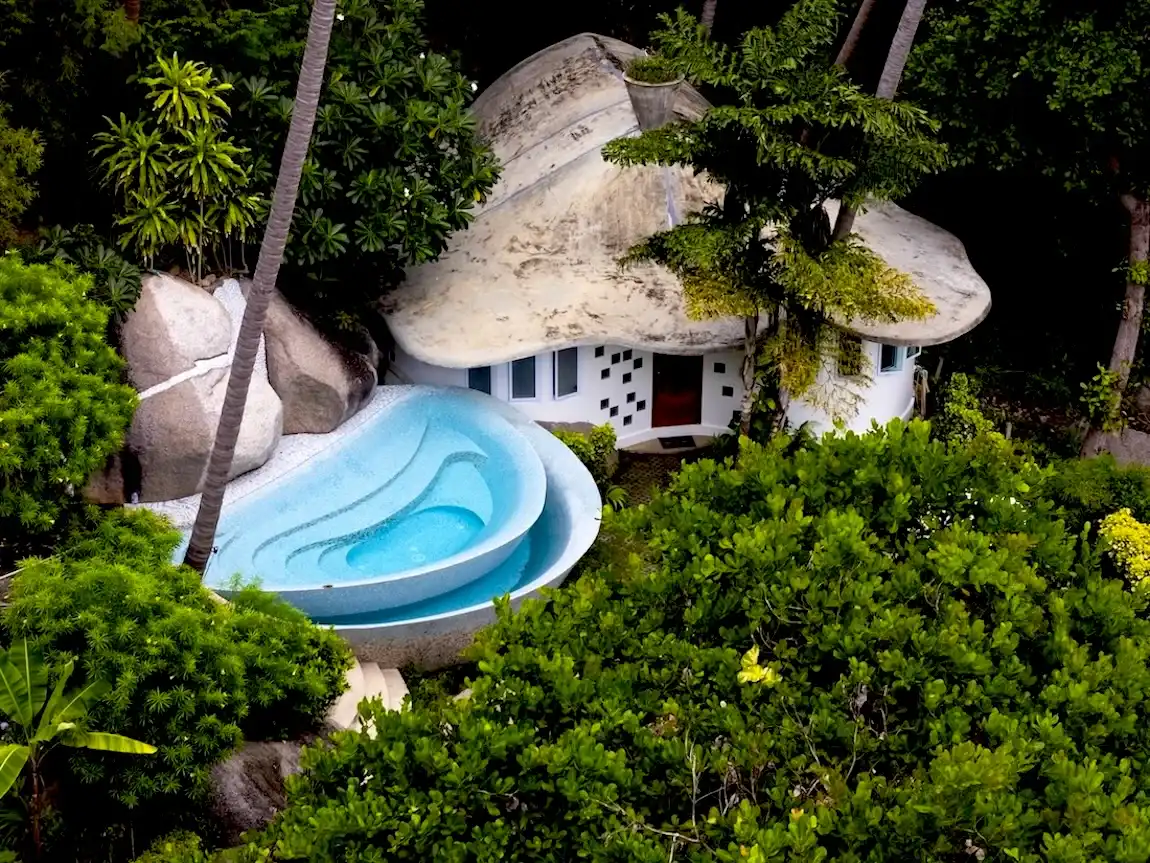 Bougainvillea Private Villa in Koh Tao surrounded by excellent greenery. Features 2 bedrooms plus a loft, 1 bathroom, and a private pool with a rock waterfall, accommodating up to 6 guests.